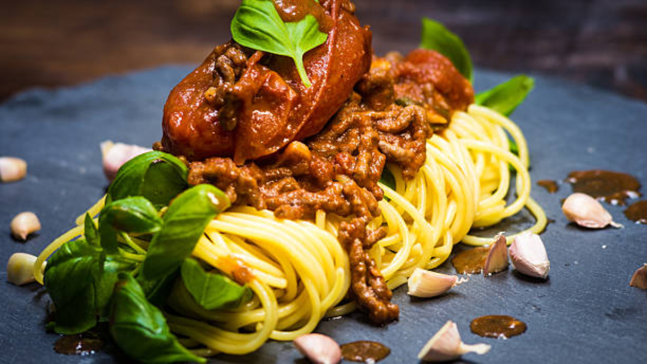 Photo of Delicious spaghetti with basil and garlic